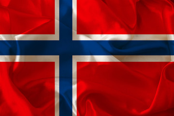 beautiful photo of the colored national flag of the modern state of Norway on textured fabric, concept of tourism, emigration, economics and politics, close up