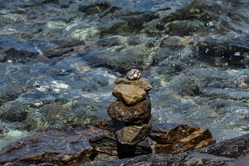 stacked stones at the water edge of Wakatipu Lake, Stacking a stone or pebble is a kind of spiritual practice to pray for a wish