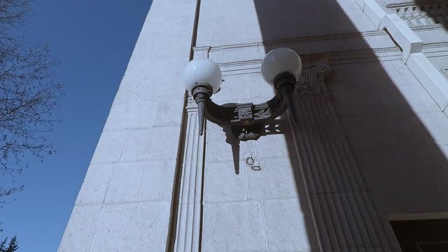 vintage metal lamps on the facade of the building with white plafonds
