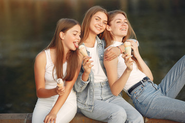 Beautiful girls walking. Women in a spring city. Ladies with ice cream.