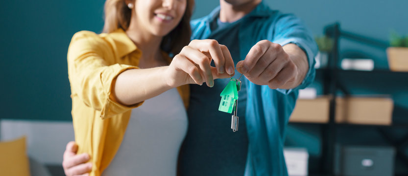 Happy couple holding house keys