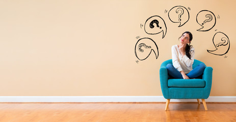 Question marks with speech bubbles with woman in a thoughtful pose in a chair