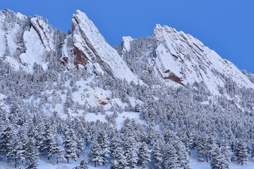 Winter landscape of the snow flocked Flatirons at dawn, Rocky Mountains, Boulder, Colorado, USA © Dean Pennala