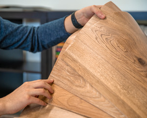 man selects from a sample store lenolium floor into a new apartment