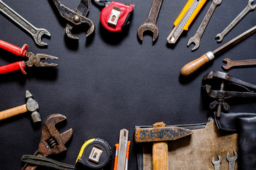 Tools for repair and reconstruction in home conditions lie on a black background