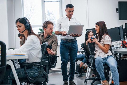 Inside of call center. Young business people working together in the modern office