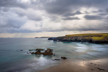 Waves breaking at the beach of Portcothan bay in Cornwall, South England