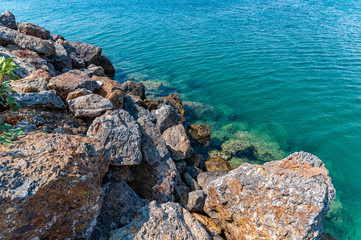 Fototapeta na wymiar Large rocks acting as a sea defence. Rocky beach