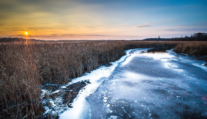 frozen stream at sunset