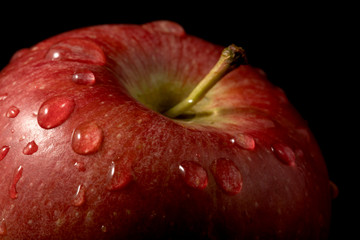 Closeup view for red fresh apple with water drop on the top