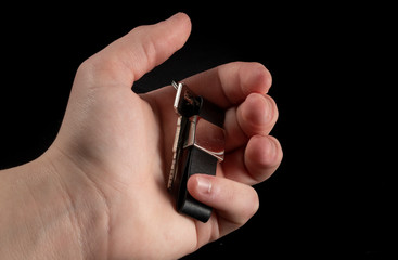 Man hand holding keys with keyring for motorbike