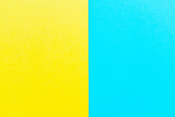 Bright yellow and sky blue cardboard background, vertical division