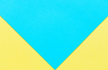 Bright yellow and sky blue cardboard background, two yellow triangles