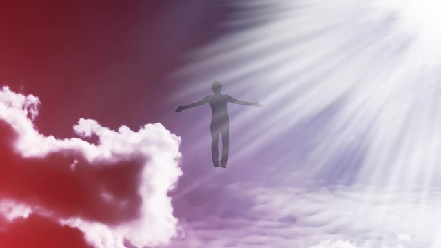 Creative 4k video with the parallax effect of the sky with moving clouds and sunlight, the silhouette of a man with spread arms, flying in bright light and dissolving in it. The concept of open mind.