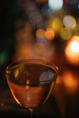 cocktail with drops of truffle oil on its surface against the background with a beautiful bokeh