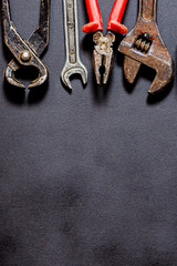 Tools for repair and reconstruction in home conditions lie on a black background