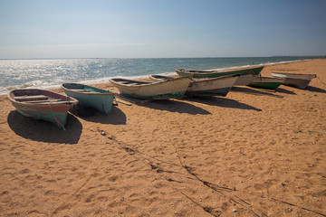 Fototapeta na wymiar Wooden fishing boats on the sandy shore. Crimea