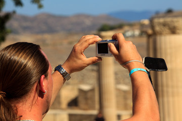 Lindos, Rhodes / Greece - June 23, 2014: Tourist take a picture in Lindos acropolis, Rhodes,...