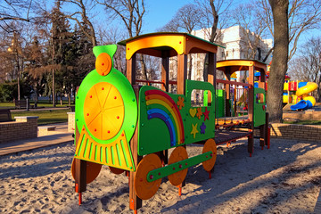 Colorful playground for little kids in the park. An empty children's playground is waiting for children. The early sunny morning in Saint Volodymyr Hill. Kyiv, Ukraine