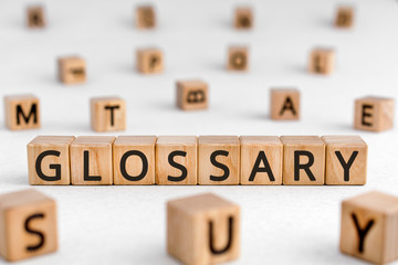 Glossary - word from wooden blocks with letters, alphabetical list of terms glossary concept,...