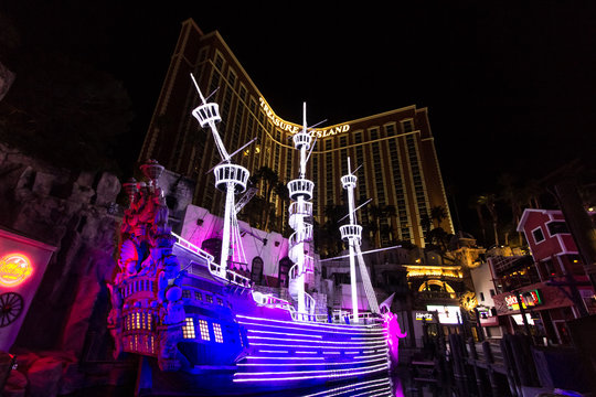 Las Vegas, Nevada, USA - February 20, 2020: Illuminated exterior of the Treasure Island Hotel and Casino completed with pirate ship on the Las Vegas Strip.