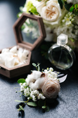 bridal bouquet, boutonniere, rings in a casket, perfume.