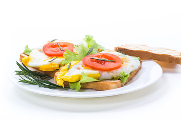 fried toasts with egg, salad, tomato in a plate