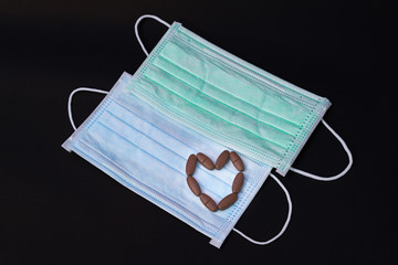 Heart shaped tablet medicine blue mask health guard face earloop surgical for Surgeon doctor, people Take care health and protect coronavirus disease COVID-19 SMOG smoke fog PM2.5 on black background