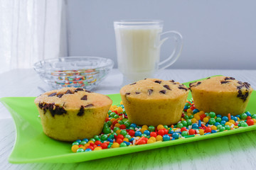 Vanilla muffin with chocolate sparks and colored