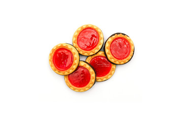 Shortbread biscuits on an isolated white background. Sweet cookies with red jam and chocolate. Top view, flat lay.