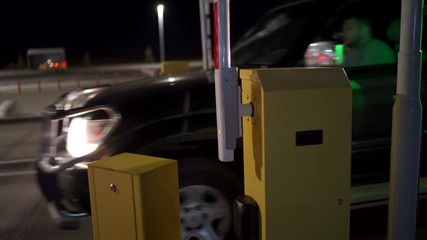 Automatic security system parking boom barrier car park system gate airport parking area access at night.