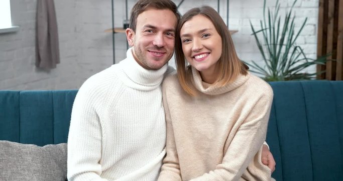 Family Portrait of newly made Young Family, perfect Couple posing to the Camera. Young Family celebrating moving to the Apartaments, looking happy, feeling good Emotions. People. Young Family. Couple.