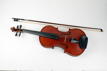 Obraz na płótnie Canvas Violin and bow put on background,show detail of stringed instrument