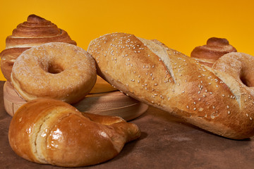 Different types of breads with yellow background