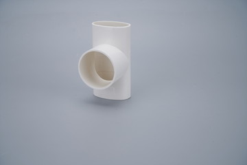 White pipe fitting on a gray background