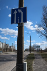 a sign hanging on a pole signifying road markings