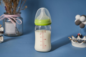 There is milk in the bottle, facing the sun under the windowsill