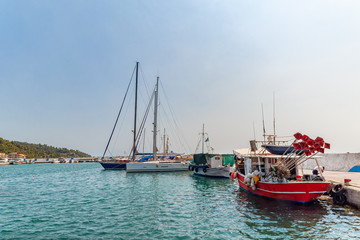 Fototapeta premium Nea Skioni, Greece - September 06, 2019: The Harbour entrance at Nea Skioni Kassandra, Chalkidiki, Central Macedonia, Greece. Greek marina with parked boats and yachts
