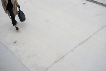 woman walking on concrete