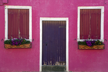 Pink house with red shutters
