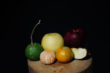 Mix fruit That contains vitamin C. isolated with black background