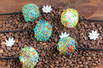 A colorful cake pops up, lying on a table. It is covered with sweet multi-colored sweets.