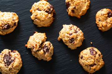 Healthy food concept Homemade Trail Mix organic Whole grains Energy and chocolate chips cookies on black slate stone background with copy space