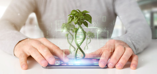 Businessman holding a DNA growing as a plant - 3d rendering