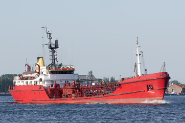 Fototapeta premium OIL PRODUCTS TANKER - The red ship sails to fuel terminal at sea port