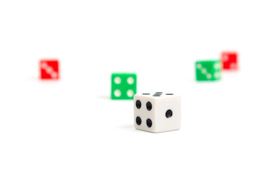 game dice scattered in white green and red on a white background isolate, side view