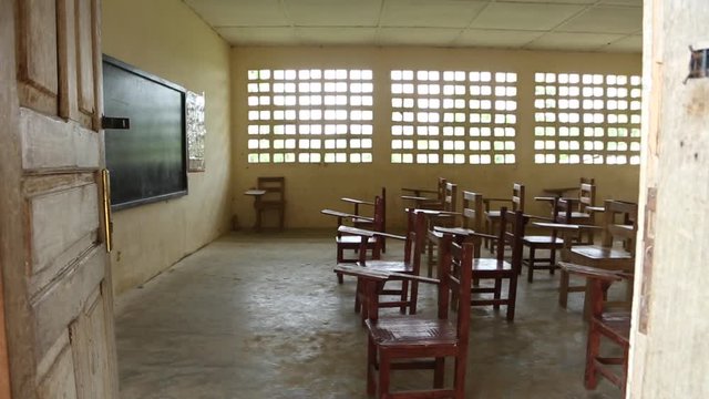 Empty Third World Classroom with Chairs and Blackboard From Outside