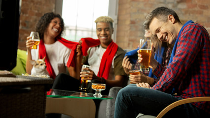 Winners. Excited people watching sport match, chsmpionship at home. Multiethnic group of friend, fans cheering for favourite national basketball, tennis, soccer, hockey team. Concept of emotions.