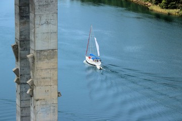 sail boat under the bridge near Skradin , near N.P. Krka, Croatia