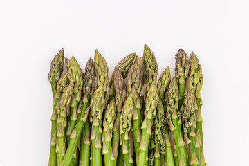 Close view of fresh green asparagus isolated on white background